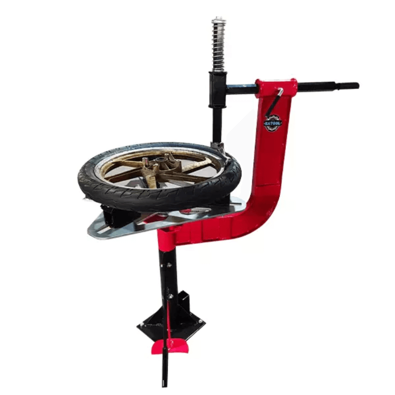 Katool KT-MOTO1001 manual motorcycle tire changer with clamped wheel mounted on red steel frame.