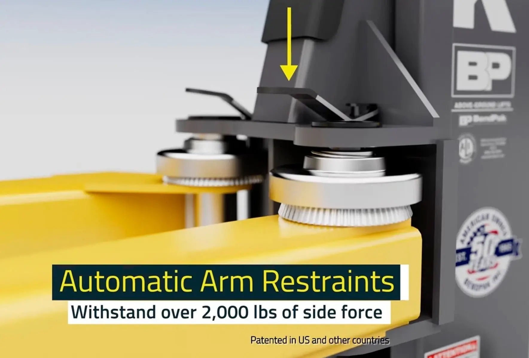 BendPak 10AP two-post lift automatic arm restraint system closeup with yellow lift arms and gray locking gears labeled “withstand over 2000 lbs of side force.”