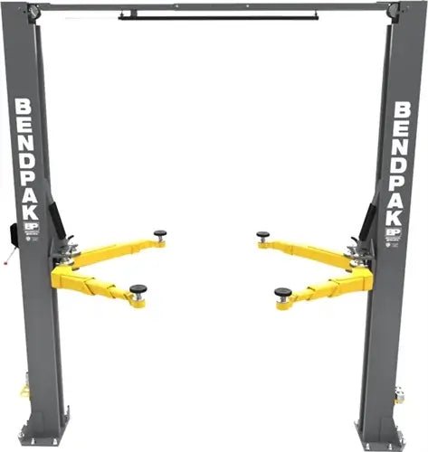 BendPak 10APX-181 two-post car lift front view showing columns, overhead beam, and yellow swing arms without vehicle