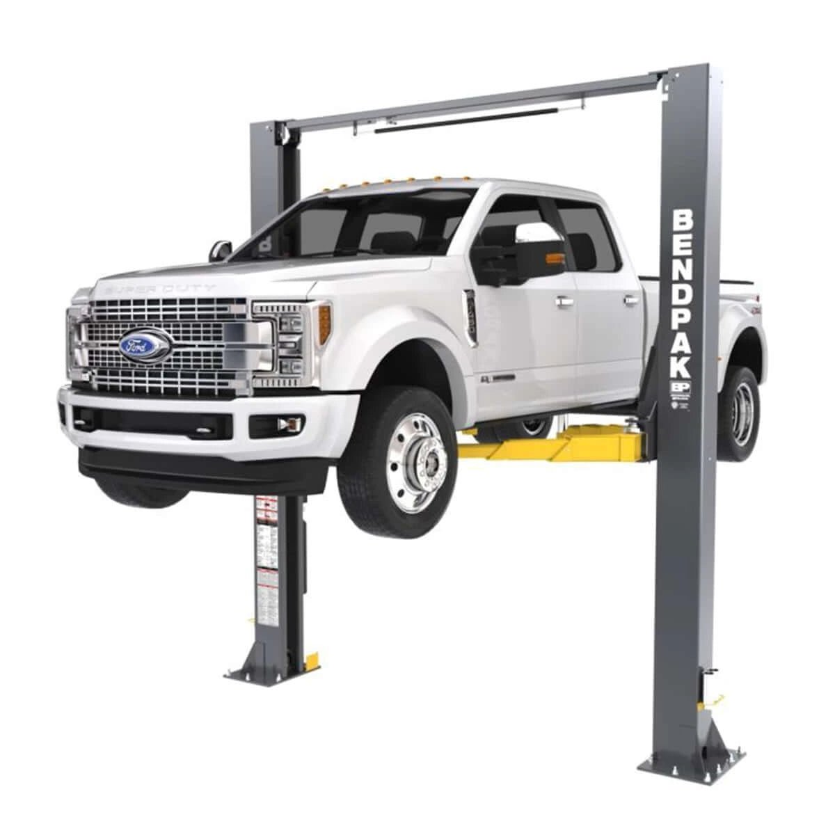 BendPak 12APX two-post lift with a pickup truck elevated, front view.