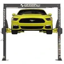 BendPak GP-7LC two-post lift front view showing a yellow Ford Mustang elevated between GrandPrix low-ceiling columns with extended arms for compact garage use.