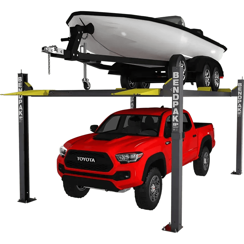 BendPak HD-7500BLX four-post lift configured for boat and vehicle storage, holding a white boat with trailer above a red Toyota Tacoma, with yellow steel ramps, tall columns, and heavy-duty runways on a transparent background.