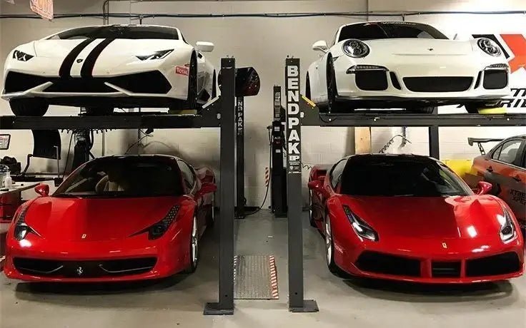 BendPak HD-7P four-post car lifts in a private garage shown storing four sports cars, highlighting compact multi-vehicle parking and high-rise lifting capacity for home or commercial use.