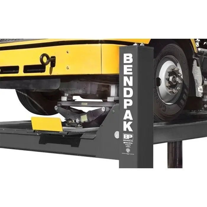 BendPak HDS-18E four post lift runway fitted with a rolling bridge jack positioned under the axle for wheel service on heavy trucks