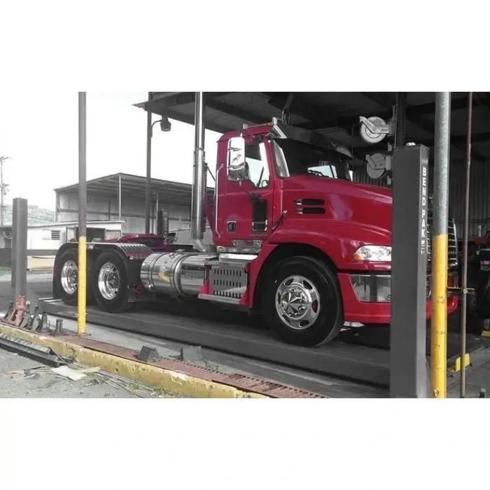 endPak HDS-18E four post lift with a semi truck at the approach ramps in a shop, showing wide runways and tall posts for large vehicles