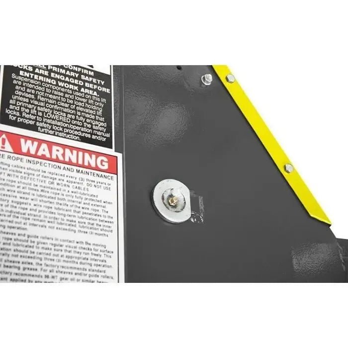 BendPak HDS-18EA alignment lift closeup of warning label and maintenance instructions on the post, highlighting cable inspection and safety procedures