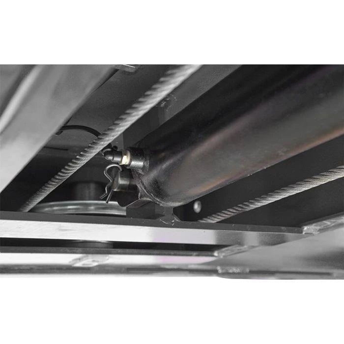 BendPak HDS-14 four-post lift underside showing hydraulic cylinder assembly with safety pin and routed steel cables.