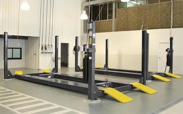 BendPak HDS-14LSX four-post alignment lift in shop setting, showing front approach ramps and integrated runways for full vehicle alignment.