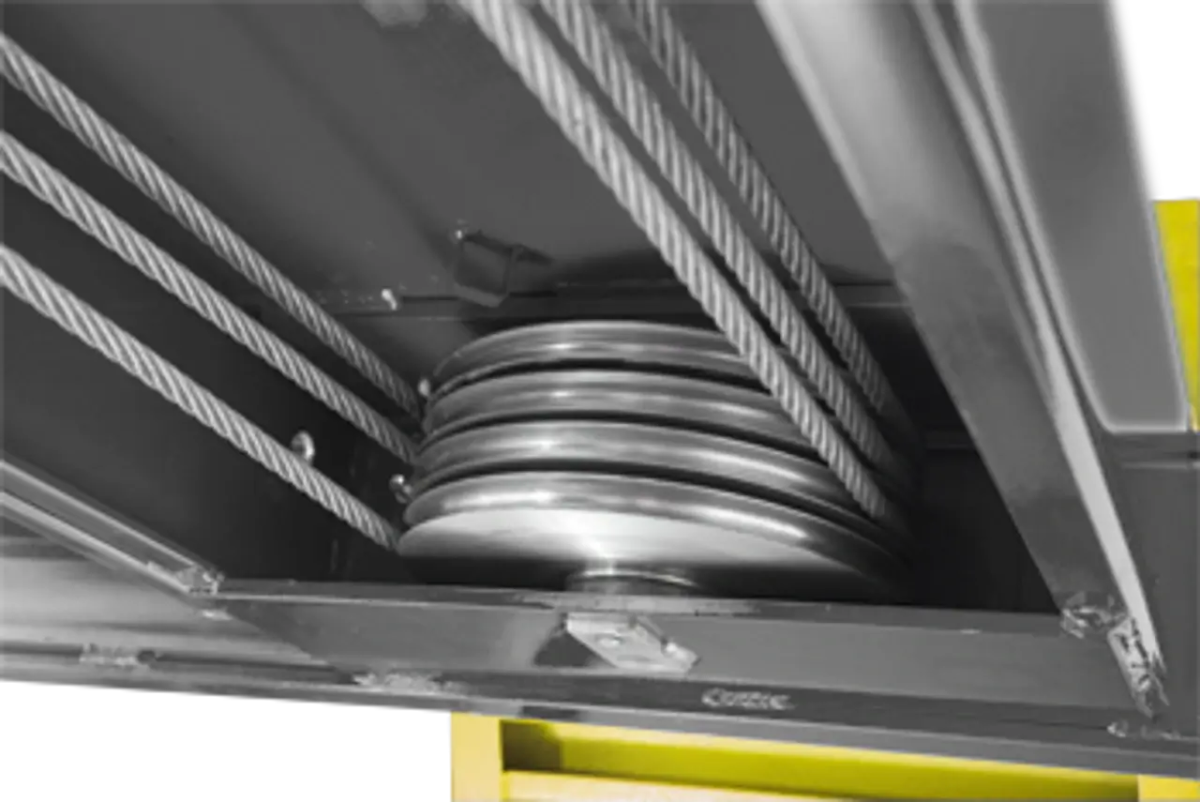 BendPak HDS-14X four-post lift underside view of multiple steel cables and pulleys ensuring even lift and balanced platform operation.