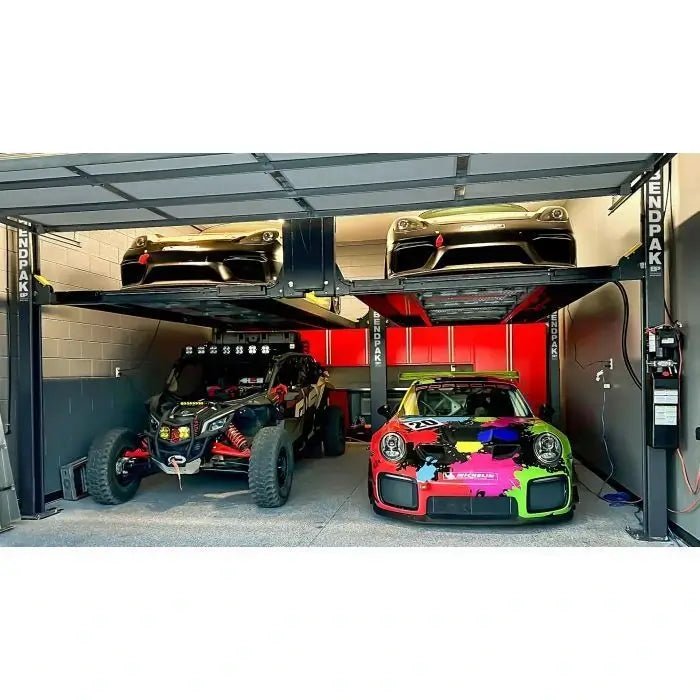 BendPak PL-12000DP four-post tandem parking lift in private garage; holding high-performance cars and off-road vehicles with overhead clearance design.
