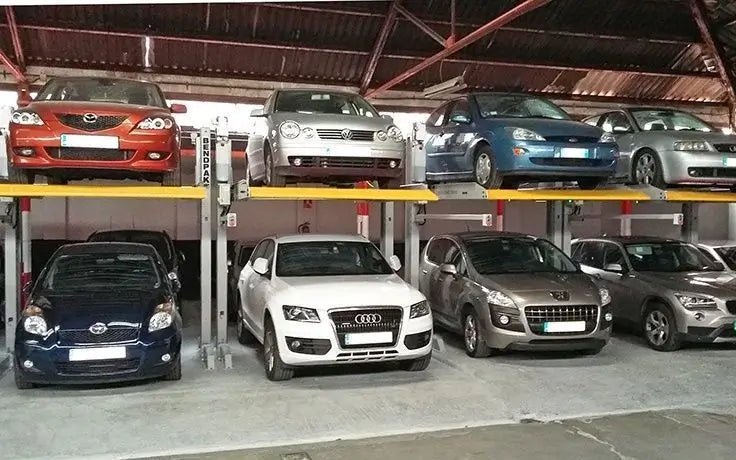 BendPak PL-6000DC two-post parking lifts used in private garage; cars stored on upper and lower levels within compact bays.