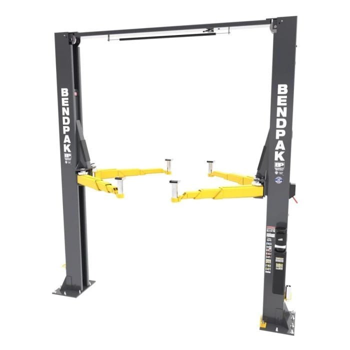 BendPak XPR-12CL two-post lift rear three-quarter view displaying overhead equalization beam, dual posts, and yellow telescoping lift arms.