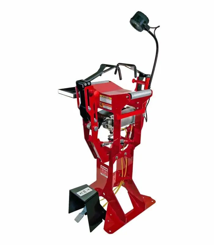Branick 5130 tire spreader, side angled view showing red steel frame, adjustable tire platform, pneumatic spreader arms, and overhead work light for efficient car and light truck tire repair.