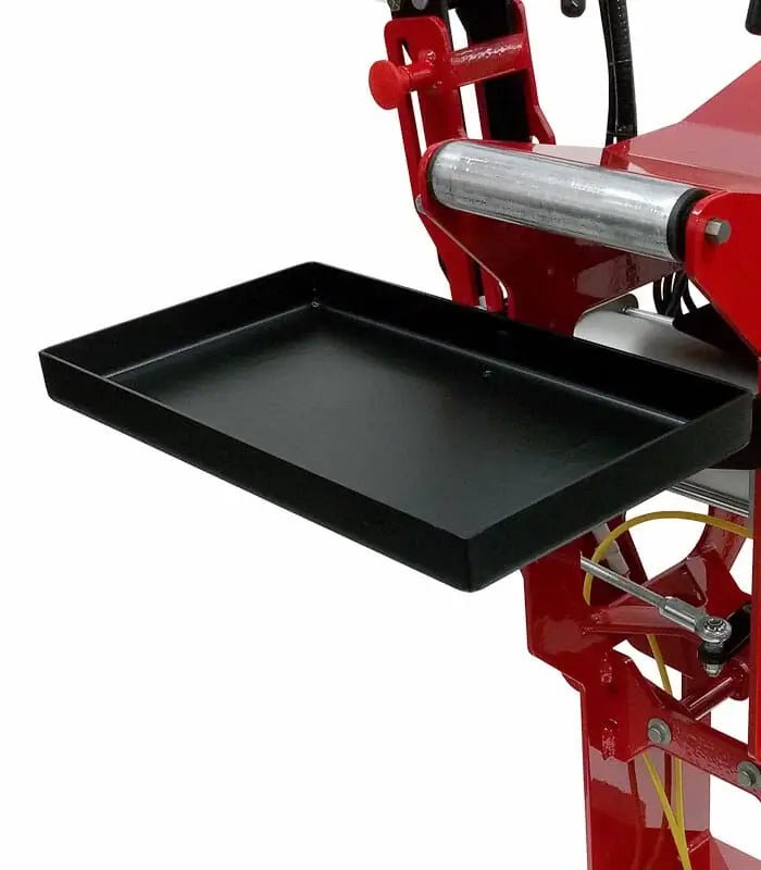 Branick 5130 tire spreader close-up showing black metal work tray attached to red frame, used for holding tools and materials during tire inspection and repair.