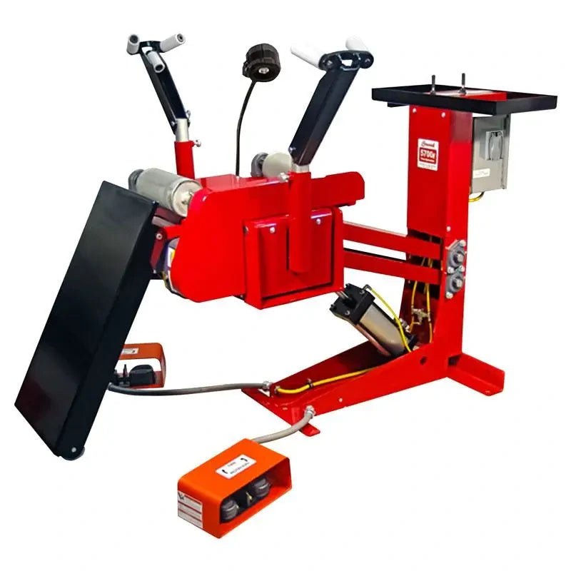 Branick 5700E tire spreader, rear view showing adjustable-height frame, pneumatic arm assembly, foot controls, and inspection platform for professional heavy-duty tire maintenance.