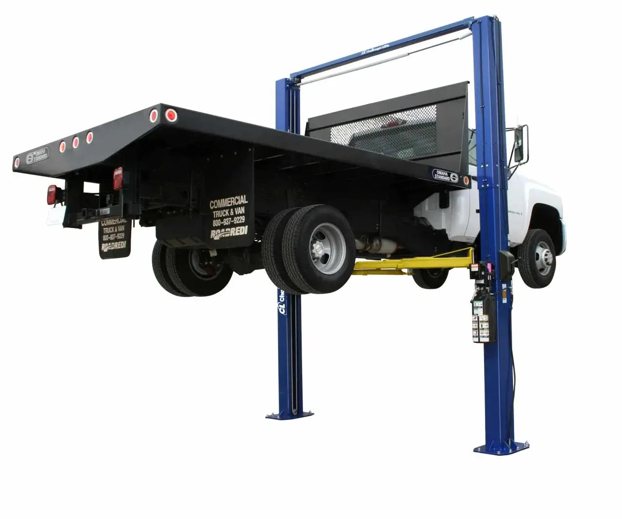 Challenger LE12 symmetric two post lift supporting a large flatbed truck, demonstrating commercial-grade strength and dual cylinder lifting performance