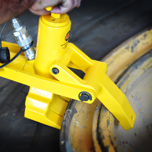 ESCO 10102 Maxi Bead Breaker clamped onto a 3-piece wheel breaking the tire bead