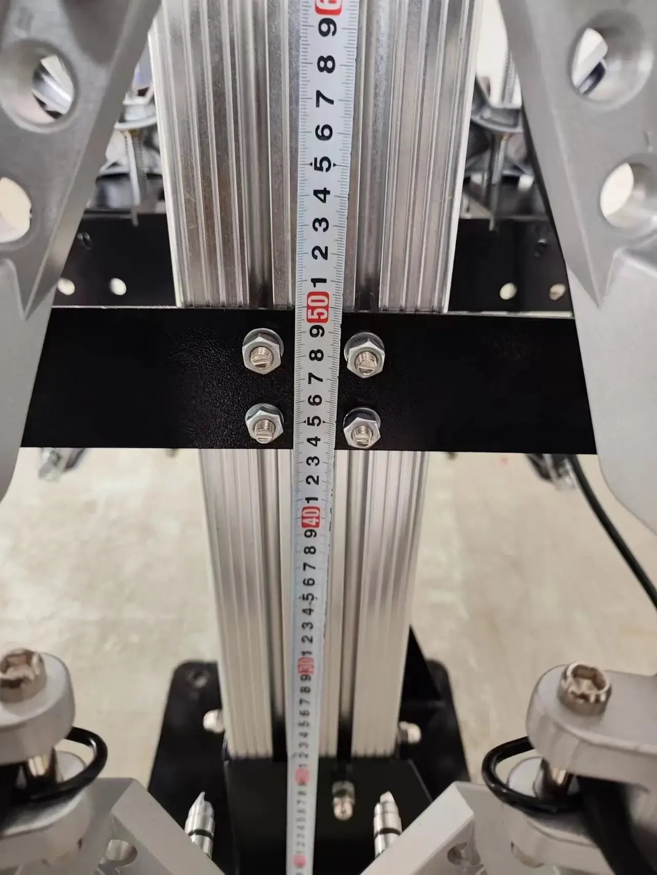 Katool KT-AV6 3D Wheel Alignment Machine closeup showing vertical height adjustment column with measurement ruler and mounting bolts for alignment calibration.