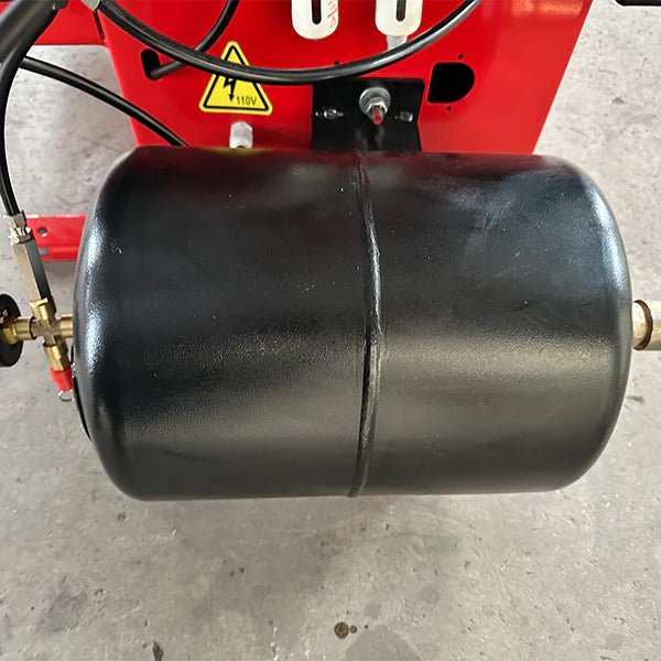 Katool KT-T850 tire changer closeup of black cylindrical air tank connected to red housing, used for pneumatic power and bead seating function