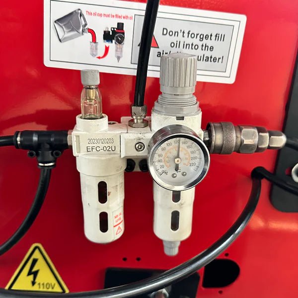 Katool KT-T850 tire changer closeup of power unit with integrated pressure regulator, gauge, and air filter assembly mounted on red housing