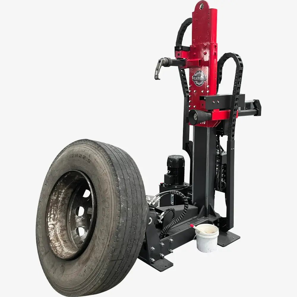 Katool KT-TV910 hydraulic truck tire changer with vertical column, hydraulic demount head and powered roller arm beside a mounted truck wheel.