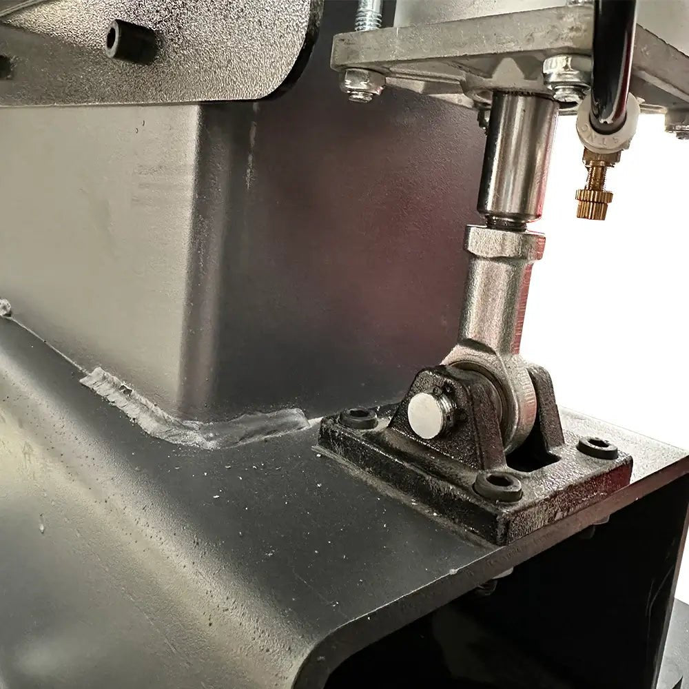 Katool RPM-80 Rim Polishing Machine close-up of bearing mount assembly with shaft, bracket, and grease fitting at base of structural frame