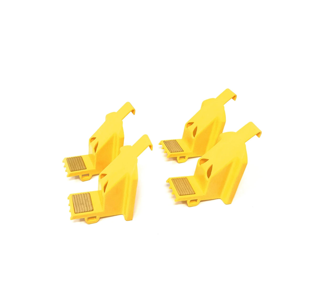 Four yellow plastic outside jaw covers arranged diagonally, showing their molded shape.