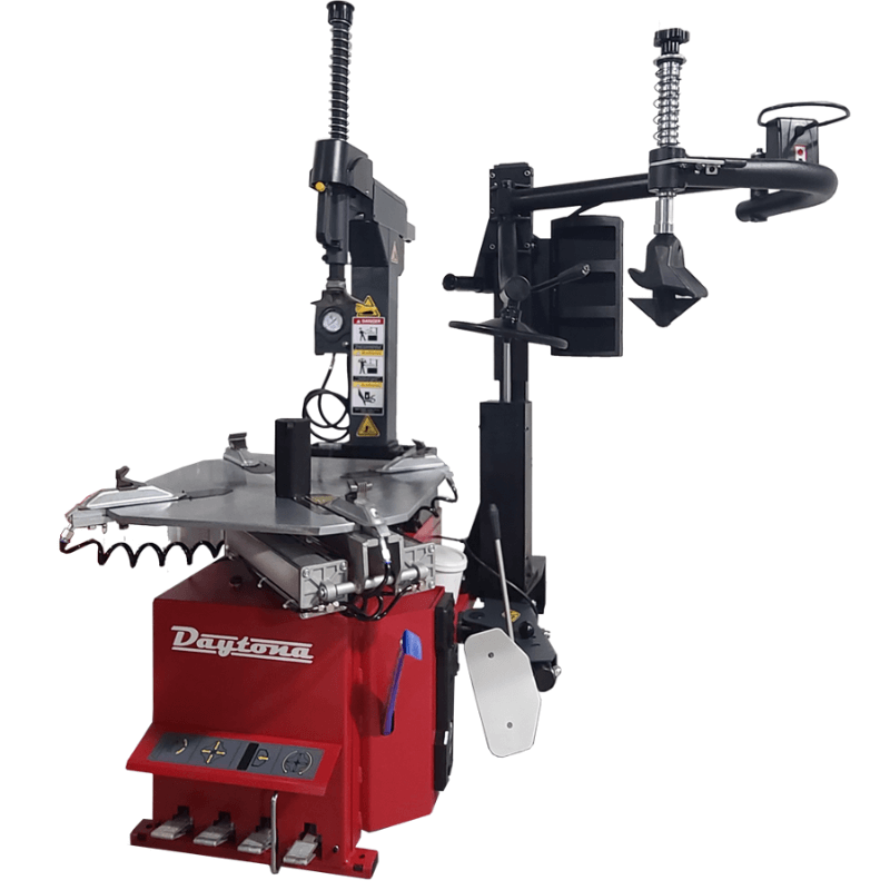 Daytona TC-890T tilt-back tire changer with a four-clamp turntable and four foot pedals, shown with an assist arm