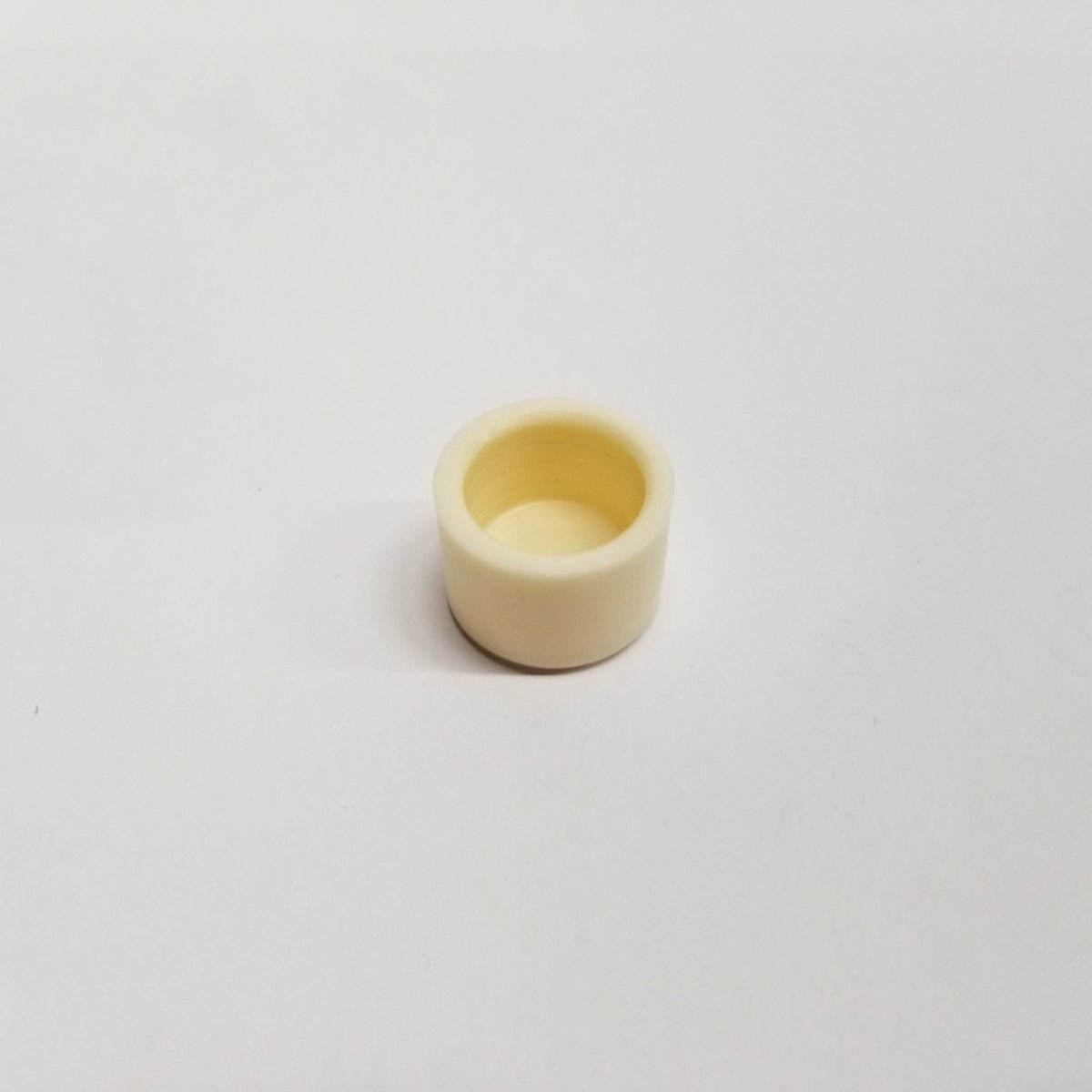 UWT UWT-1200-1 replacement hammer cap shown as a small cylindrical piece with an open top on white background.