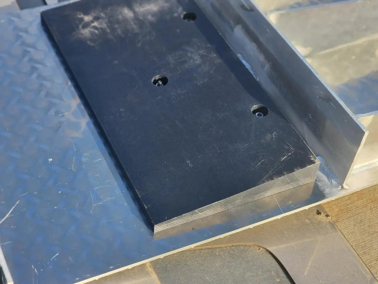 Autostacker 5174106 A6S EXT48 aluminum ramp bracket detail showing black mounting block secured to ramp base for stable alignment