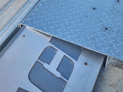 Autostacker 5174106 A6S EXT48 ramp underside closeup showing mounting plate and connection hardware at platform joint