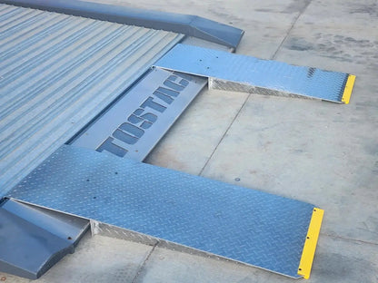 Autostacker 5174106 A6S EXT48 aluminum approach ramps pair attached to lift platform, showing extended 48 in length and yellow safety ends