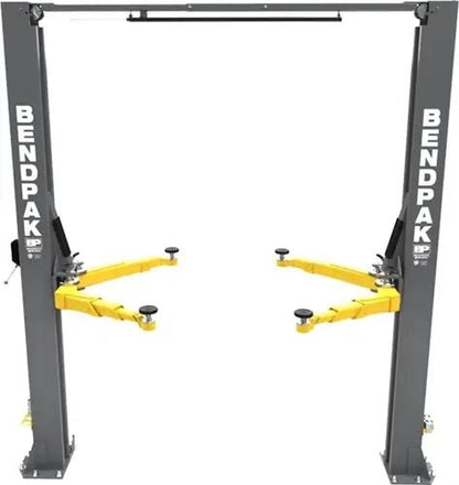 BendPak 10APX-181 two-post car lift front view showing columns, overhead beam, and yellow swing arms without vehicle