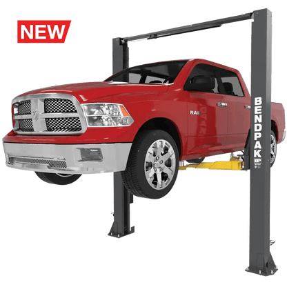 BendPak 10APX two-post lift in hero view raising a red pickup truck, featuring clearfloor design, overhead beam, and yellow triple-telescoping lift arms.