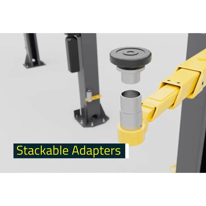 BendPak 10APX two-post lift showing stackable height adapters above yellow lift arm pad assembly, illustrating interchangeable contact extension system.