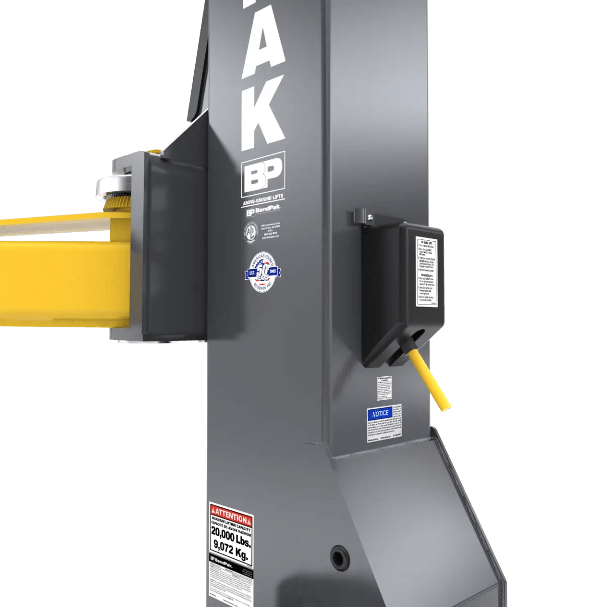 BendPak 20AP-192 two-post lift closeup of safety lock mechanism on column showing control lever, lock housing, warning labels, and yellow lift arm attachment point.