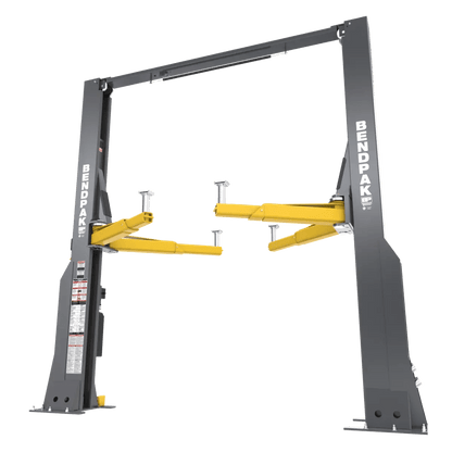 BendPak 20AP two-post lift shown in angled front-left view highlighting gray heavy-duty steel columns, yellow lifting arms, top crossbeam, and control panel decal.