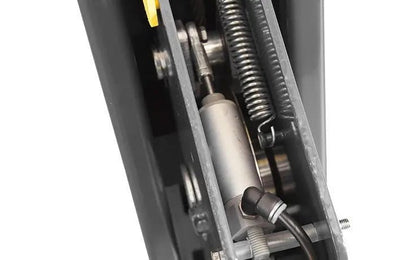 Close-up view of BendPak four-post lift redundant safety lock system showing spring-loaded locking mechanism and actuator components inside lift column for enhanced safety.