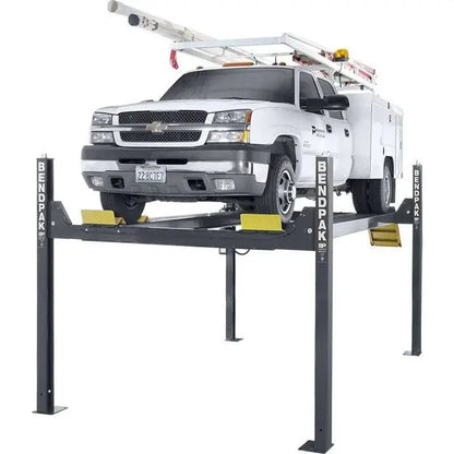BendPak HD-14T four-post heavy-duty lift shown raising a utility truck, featuring tall posts, yellow safety ramps, and 14,000 lb lifting capacity for commercial use.