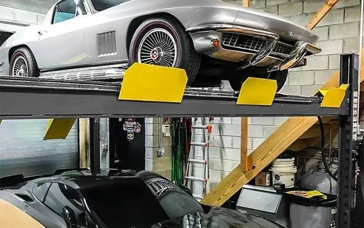 BendPak HD-9SWX four-post lift installed in a garage showing double-wide configuration with two cars stacked, yellow wheel stops, and heavy-duty column structure.