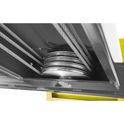 BendPak HDS-14 four-post lift underside view showing multiple heavy-duty steel cable sheaves and lift cables for synchronized platform movement.