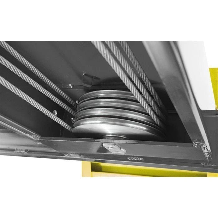 BendPak HDS-14 four-post lift underside view showing multiple heavy-duty steel cable sheaves and lift cables for synchronized platform movement.