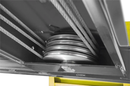 BendPak HDS-14X four-post lift underside view of multiple steel cables and pulleys ensuring even lift and balanced platform operation.