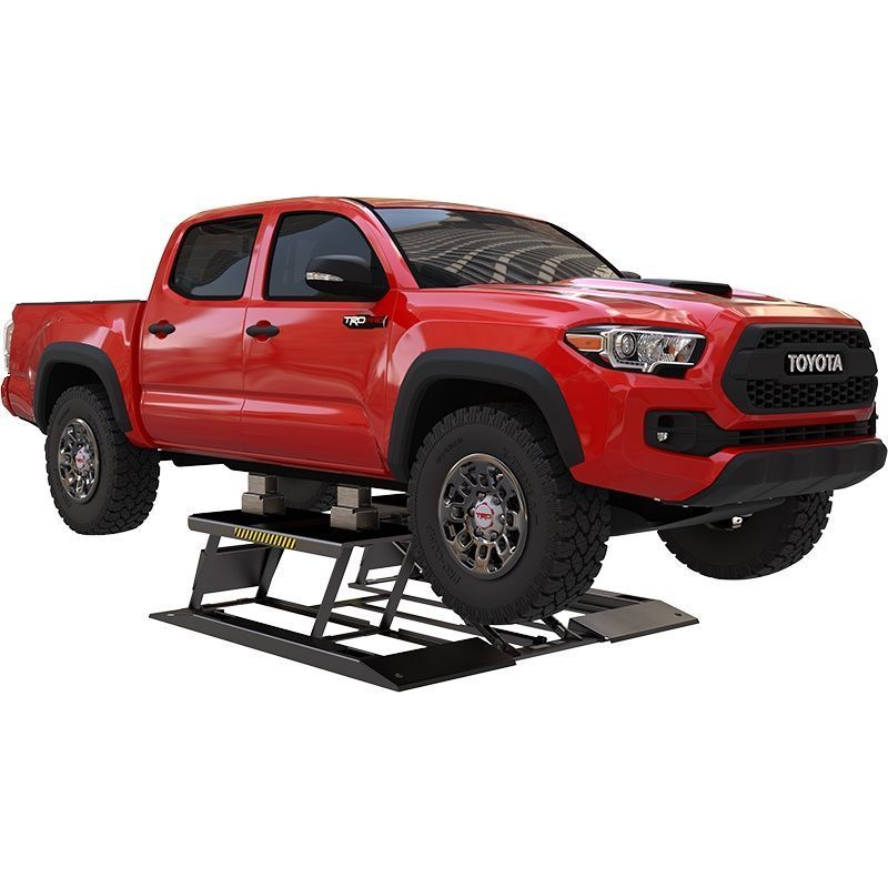 BendPak LR-10000 portable low-rise scissor lift raising a red pickup truck, angled front view highlighting the twin-platform lift and scissor mechanism beneath the vehicle.