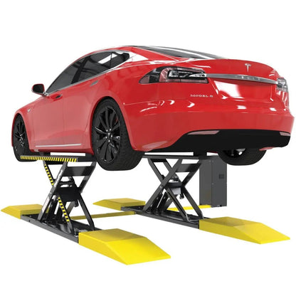 BendPak MDS-6EXT mid-rise extended scissor lift raising a red Tesla Model S, showing rear and side profile; includes yellow ramps and safety-striped platforms.