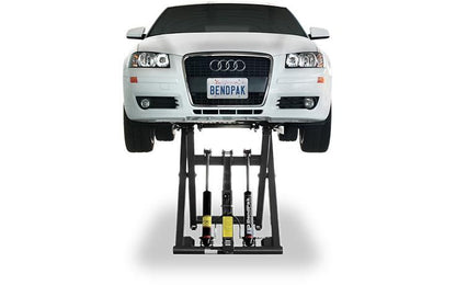 Front view of BendPak MD-6XP mid-rise car lift with yellow safety decals; showcases dual hydraulic pistons and sturdy frame construction.