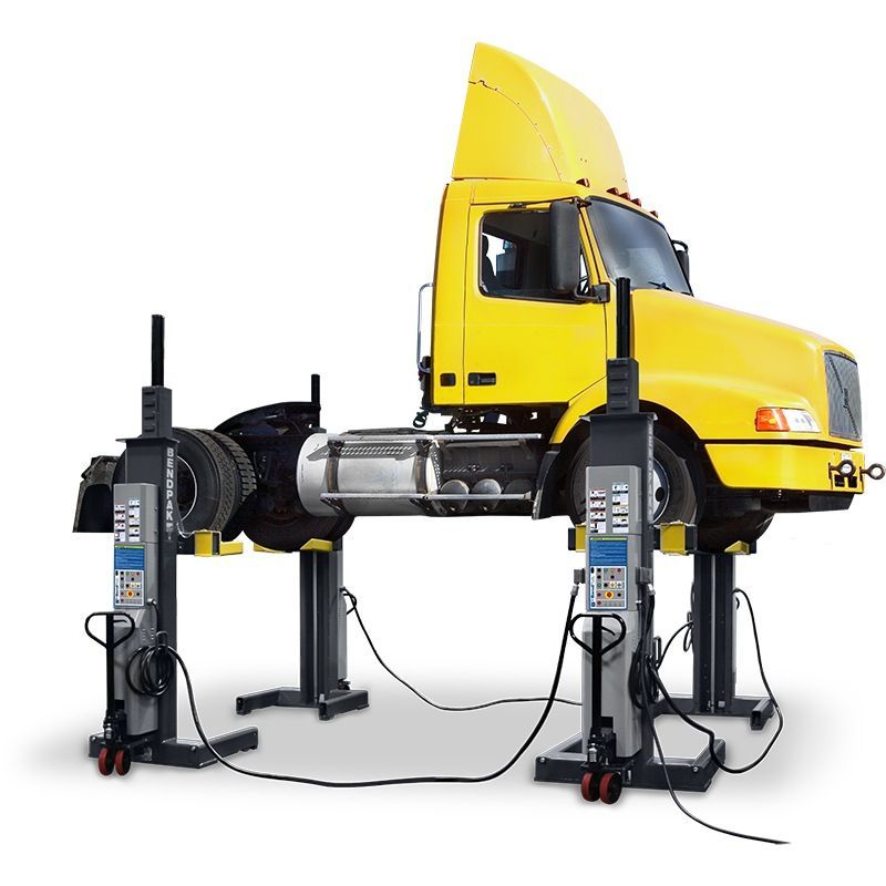 BendPak PCL-18B-4 mobile column lift system raising a yellow semi-truck; four wireless hydraulic columns with adjustable forks and control interface shown in use.