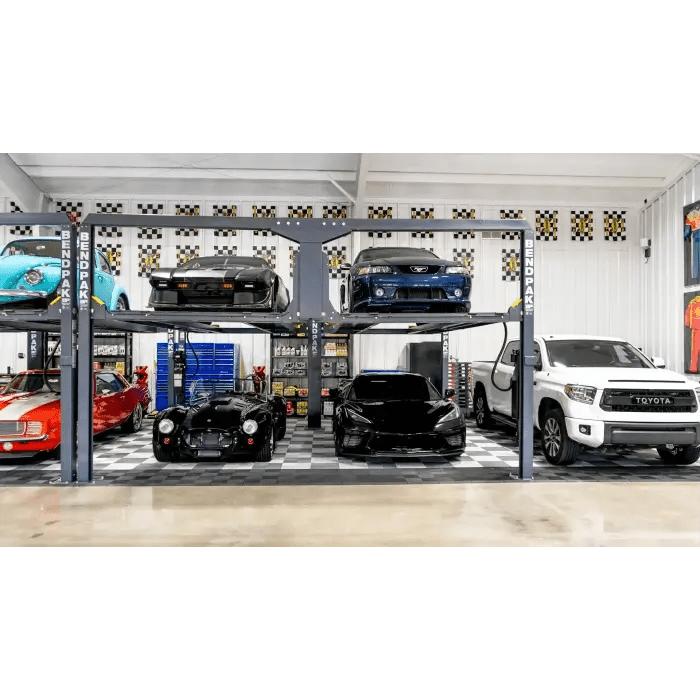 BendPak PL-12000DP four-post tandem parking lifts installed in garage; multiple vehicles including classics and exotics displayed in two-tier storage.