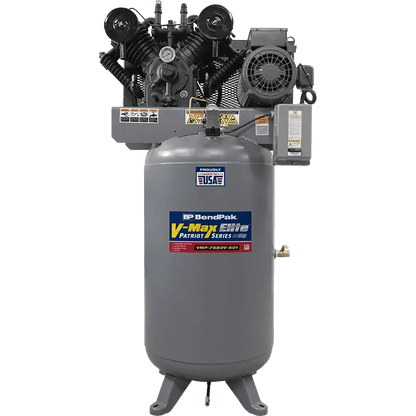 Front view of BendPak VMP-7580V-601 V-Max Patriot air compressor with 7.5 HP motor and 80-gallon vertical tank, showing dual-cylinder cast iron pump, belt drive system, and gray steel body on transparent background.