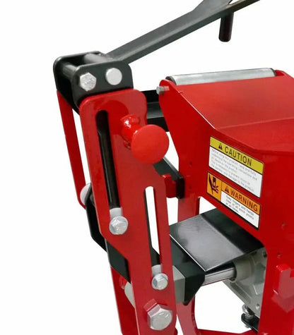 Branick 5130 tire spreader close-up showing red adjustable arm mechanism with pivot bolts, handle lever, and safety labels used for precise tire spreading control.